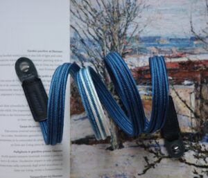 Close up of HOZUMA Blue Mt. Fuji Kumihimo silk camera strap showing braided texture, attached to a black Leica M11 camera.