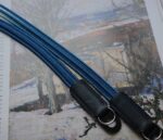 Close up of HOZUMA Blue Mt. Fuji Kumihimo silk camera strap showing braided texture, attached to a black Leica M11 camera.